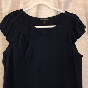 Navy colored blouse features ruffled cap sleeve